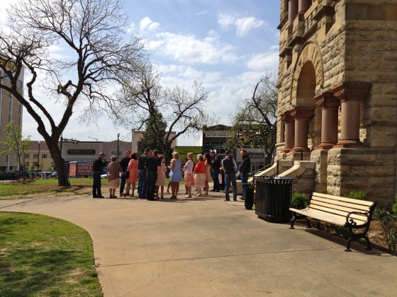 An eastern view of the courthouse with a wedding party waiting for the big event.